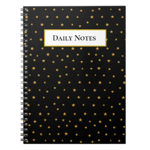 Golden stars on black notebook