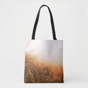 GOLDEN SUN OVER A FOREST TOTE BAG