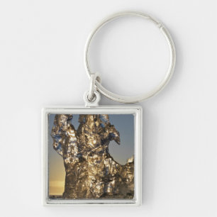 Golden sunrise seen through iceberg formation keychain