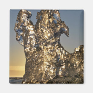 Golden sunrise seen through iceberg formation magnet