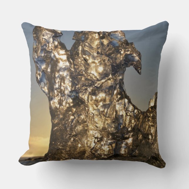 Golden sunrise seen through iceberg formation throw pillow (Front)