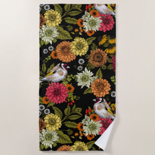 Goldfinches in the garden on black beach towel