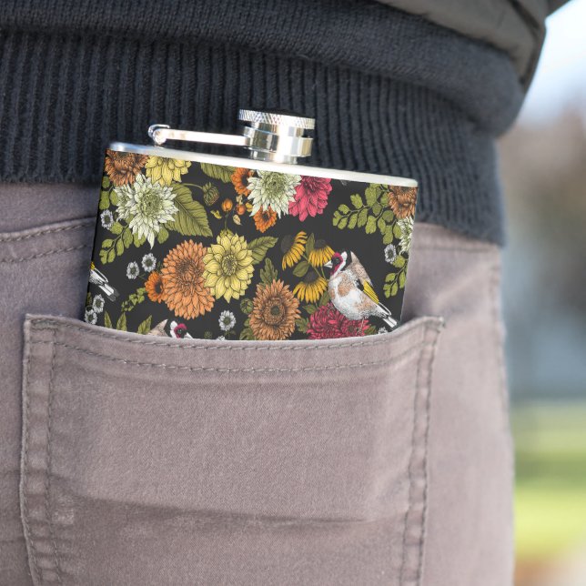 Goldfinches in the garden on black hip flask (In Situ)