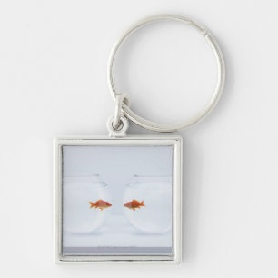 Goldfish in separate fishbowls looking face to fac keychain