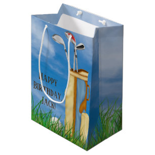 golf bag and clubs with ball in grass