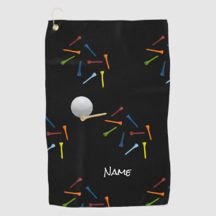 Golf ball and colourful tees on black background golf towel