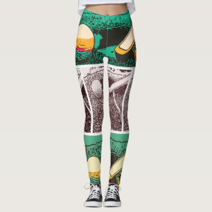 Golf ball and putter on green leggings