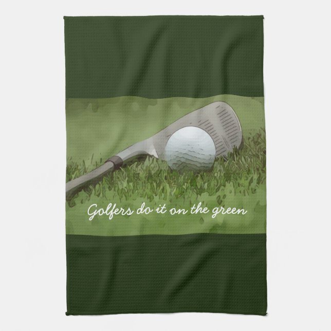 Golf ball and sand wedge golfers do it on green kitchen towel (Vertical)