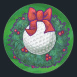 Golf Ball Christmas Wreath on Green Classic Round Sticker<br><div class="desc">It's Holiday tee time! Get your golf swing ready and your holiday spirit going with our festive golf ball decked out for the holidays inside a holly wreath with a bright red bow against our signature texture green. Our original sports ball art is a hole in one with golf players...</div>