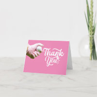 Golf ball is in lady golfer's hand on pink 