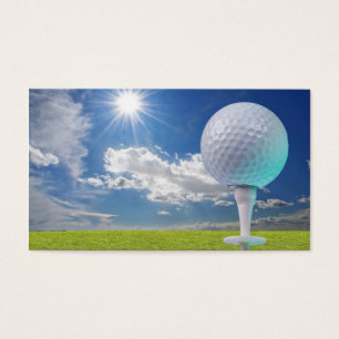 golf ball on a tee with grass