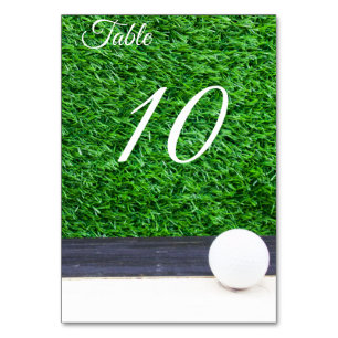 Golf ball on green grass table number