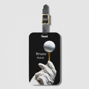 Golf  ball on pin next to hole black background  luggage tag