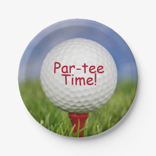 golf ball on red tee in grass paper plate