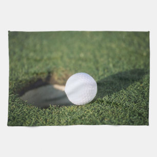 Golf Ball on the edge of hole Kitchen Towel