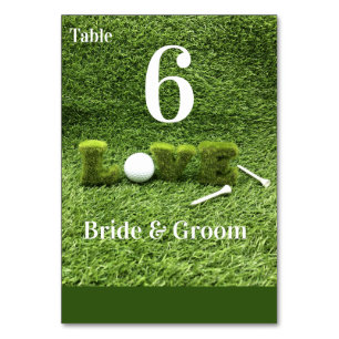 Golf ball with love letter are on green grass table number