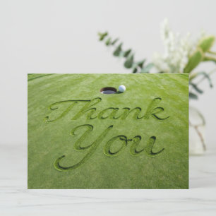 Golf ball with text Thank you on green grass Card