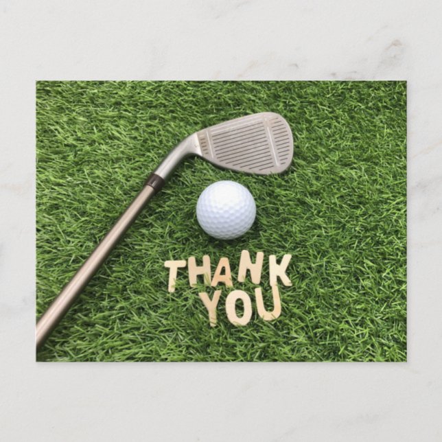 Golf ball with thank you word on green grass postcard (Front)