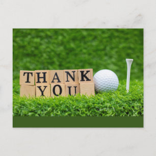 Golf ball with thank you word on green grass postcard