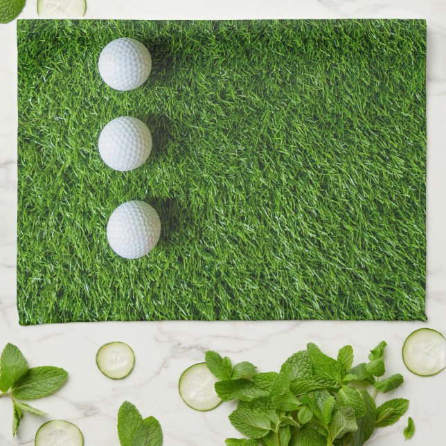 Golf Balls are on green grass Kitchen Towel (Folded)
