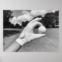 Golf Glove Holding Ball on Fairway