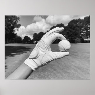 Golf Glove Holding Ball on Fairway Poster