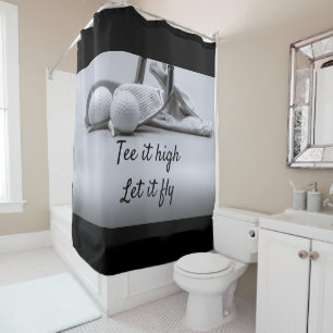 Golf tee and golf ball are on black background