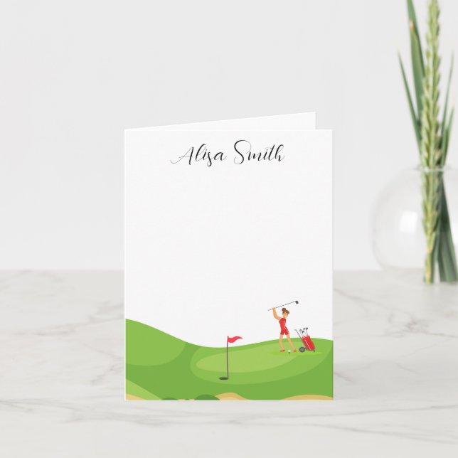Golfer Woman is on green grass in golf course  Note Card (Front)
