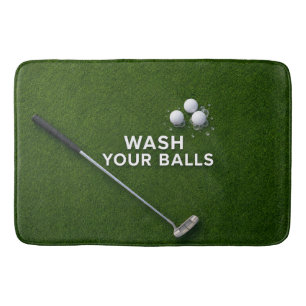 Golfer's bathroom with golf balls and putter bath mat