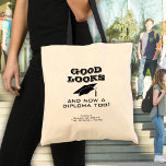 Good Looks and Now Diploma Too Funny Graduation  Tote Bag<br><div class="desc">Good Looks and Now a Diploma Too Funny Graduation Tote Bag. Funny quote for a graduate - Good looks and now a diploma too. Black graduation cap and typography. Add the graduate's name,  class year and the school name - a great gift for a graduate who graduated.</div>