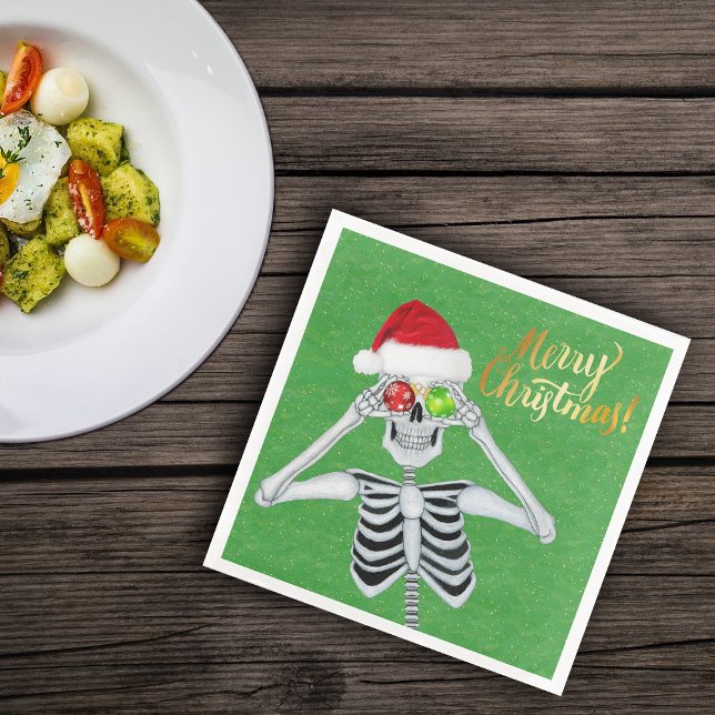 Goofy Christmas Skeleton Ornament Eyes Hat Green Napkin (Fun skeleton holding ornaments to eyes on green Merry Christmas paper party napkins)