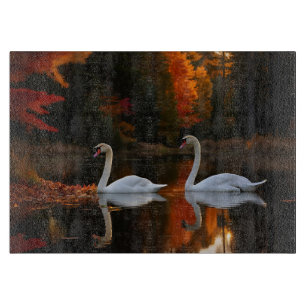 Graceful White Swans Gliding Across Autumn Pond Cutting Board