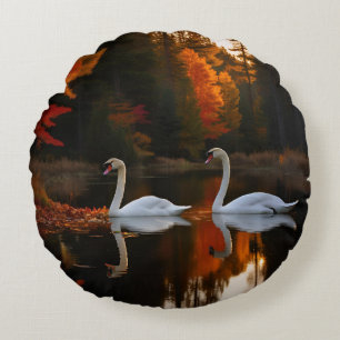 Graceful White Swans Gliding Across Autumn Pond Round Pillow