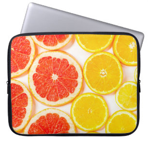 Gradient colour citrus slices on white backgrounda laptop sleeve