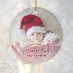 Grandparents 1st Christmas Photo Black Script Ceramic Ornament<br><div class="desc">Help them celebrate their first grandchild with this beautiful modern keepsake ornament. The off-black text reads "Our first Christmas as grandparents, " with the word "grandparents" in elegant handwriting script with flourishes before and after. Easily replace the sample image with your favorite photo of the new baby, and add his...</div>