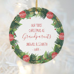 Grandparents First Christmas Baby Photo Wreath Ceramic Ornament<br><div class="desc">This design features a hand-drawn Christmas wreath of pine boughs and red ornaments, surrounding the words "Our First Christmas as Grandparents" in whimsical red printing and handwriting fonts. Personalize it by adding baby's name and the year. Customize the reverse side with a favourite photo of the new grandchild, encircled by...</div>