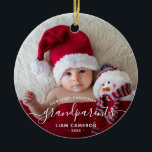 Grandparents First Christmas Photo White Script Ceramic Ornament<br><div class="desc">Help them celebrate their first grandchild with this beautiful modern keepsake ornament. The white text reads "Our first Christmas as grandparents, " with the word "grandparents" in elegant handwriting script with flourishes before and after. Easily replace the sample image with your favourite photo of the new baby, and add his...</div>