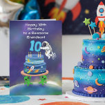 Grandson Happy 10th Birthday Astronaut with Cool  Card<br><div class="desc">Celebrate your grandson’s 10th birthday with a bold space explorer theme featuring an astronaut positioning the number nine on a galaxy-inspired cake. Planets wrap around the tiers, a rocket cuts through the scene, and the glow of Earth adds atmosphere beneath it all. The addition of subtle alien characters enhances the...</div>