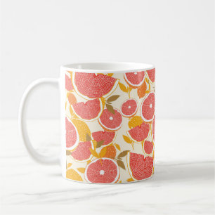 Grapefruit and halved slices with leaves on white. coffee mug