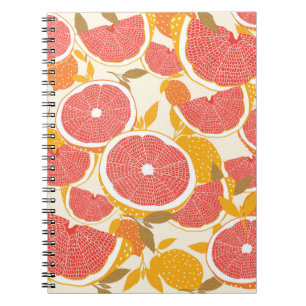 Grapefruit and halved slices with leaves on white. notebook