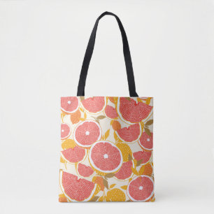 Grapefruit and halved slices with leaves on white. tote bag