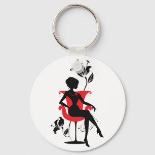 Graphic silhouette of a woman sitting in red chair keychain