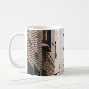 GRAY CONCRETE ALLEY DURING DAYTIME COFFEE MUG