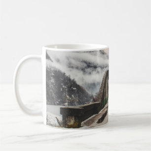 GRAY CONCRETE ARCH BRIDE BESIDE LEAFLESS TREE NEAR COFFEE MUG
