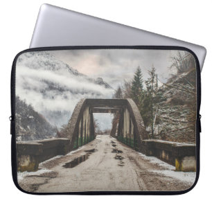 GRAY CONCRETE ARCH BRIDE BESIDE LEAFLESS TREE NEAR LAPTOP SLEEVE