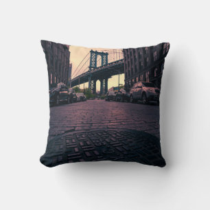 GRAY VEHICLE AT ROAD BESIDE CONCRETE BUILDING THROW PILLOW
