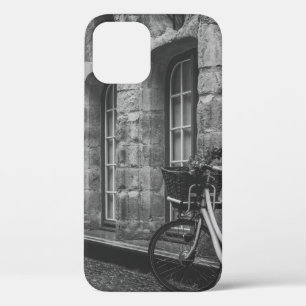 GRAYSCALE PHOTO OF BIKE PARKED BESIDE BUILDING iPhone 12 CASE