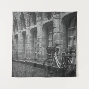 GRAYSCALE PHOTO OF BIKE PARKED BESIDE BUILDING TAPESTRY
