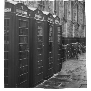 GRAYSCALE PHOTO OF FOUR TELEPHONE BOOTHS LINED UP