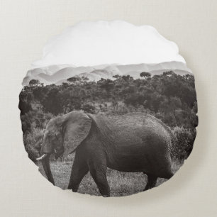 GRAYSCALE PHOTO OF GRAY ELEPHANT NEAR TREES ROUND PILLOW